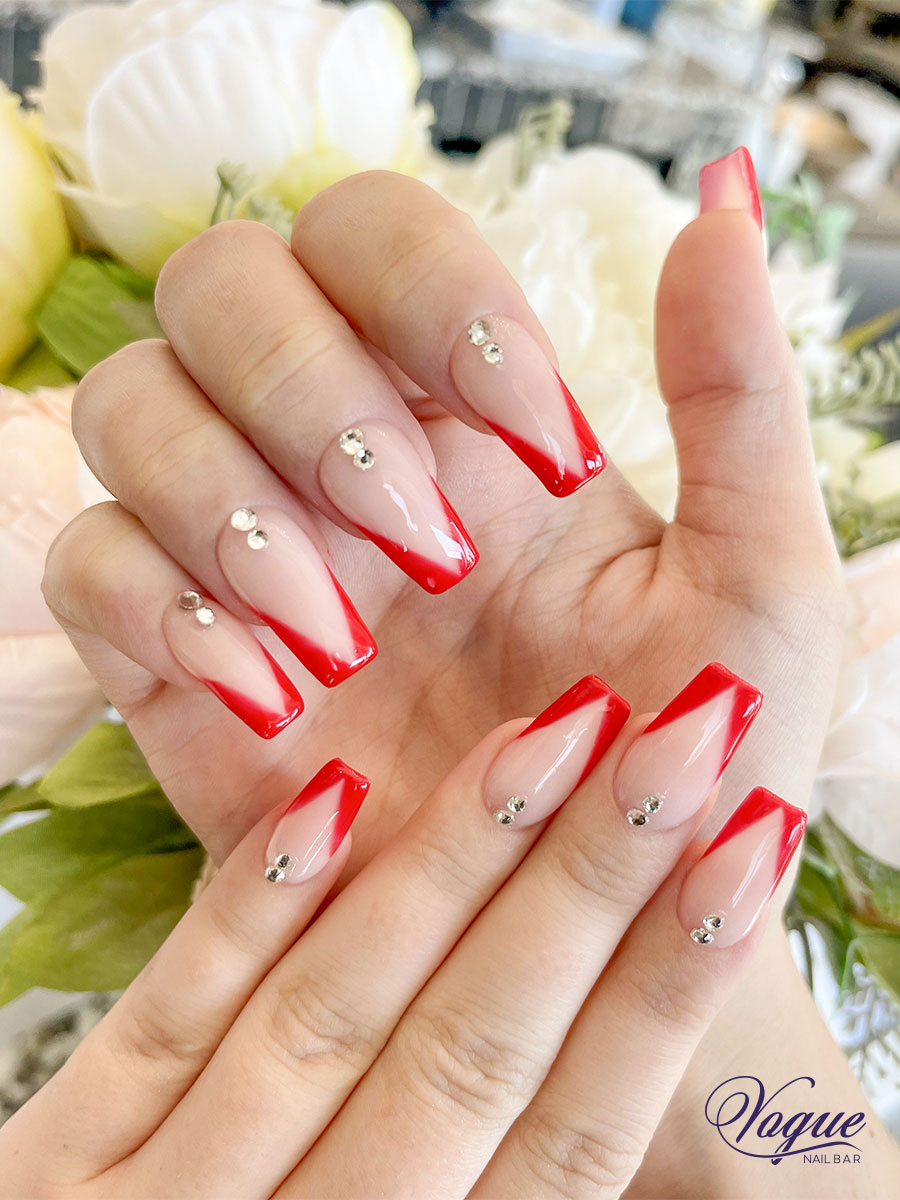 Red and nude ombre nails with crystal embellishments