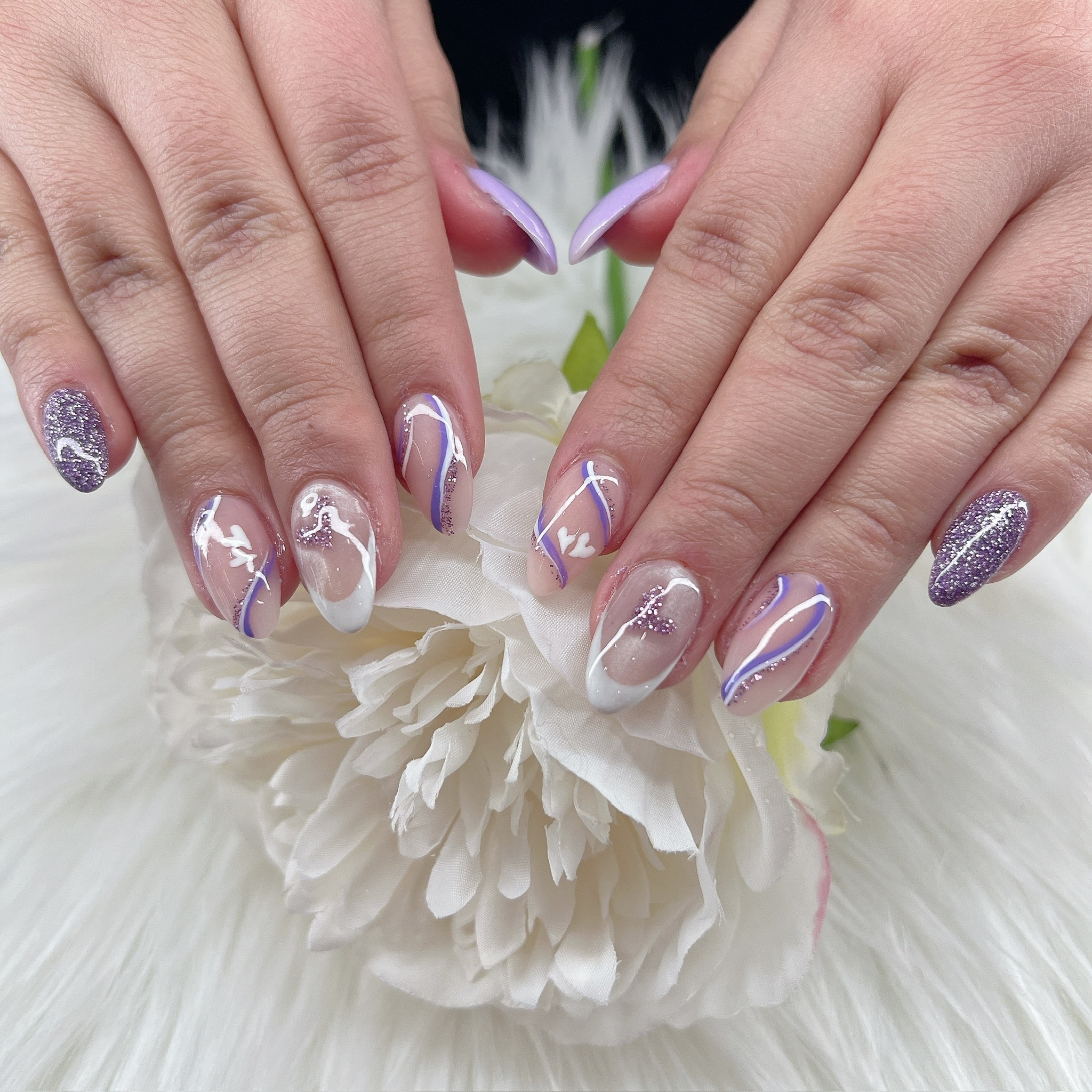 Purple glitter and white swirl nail art