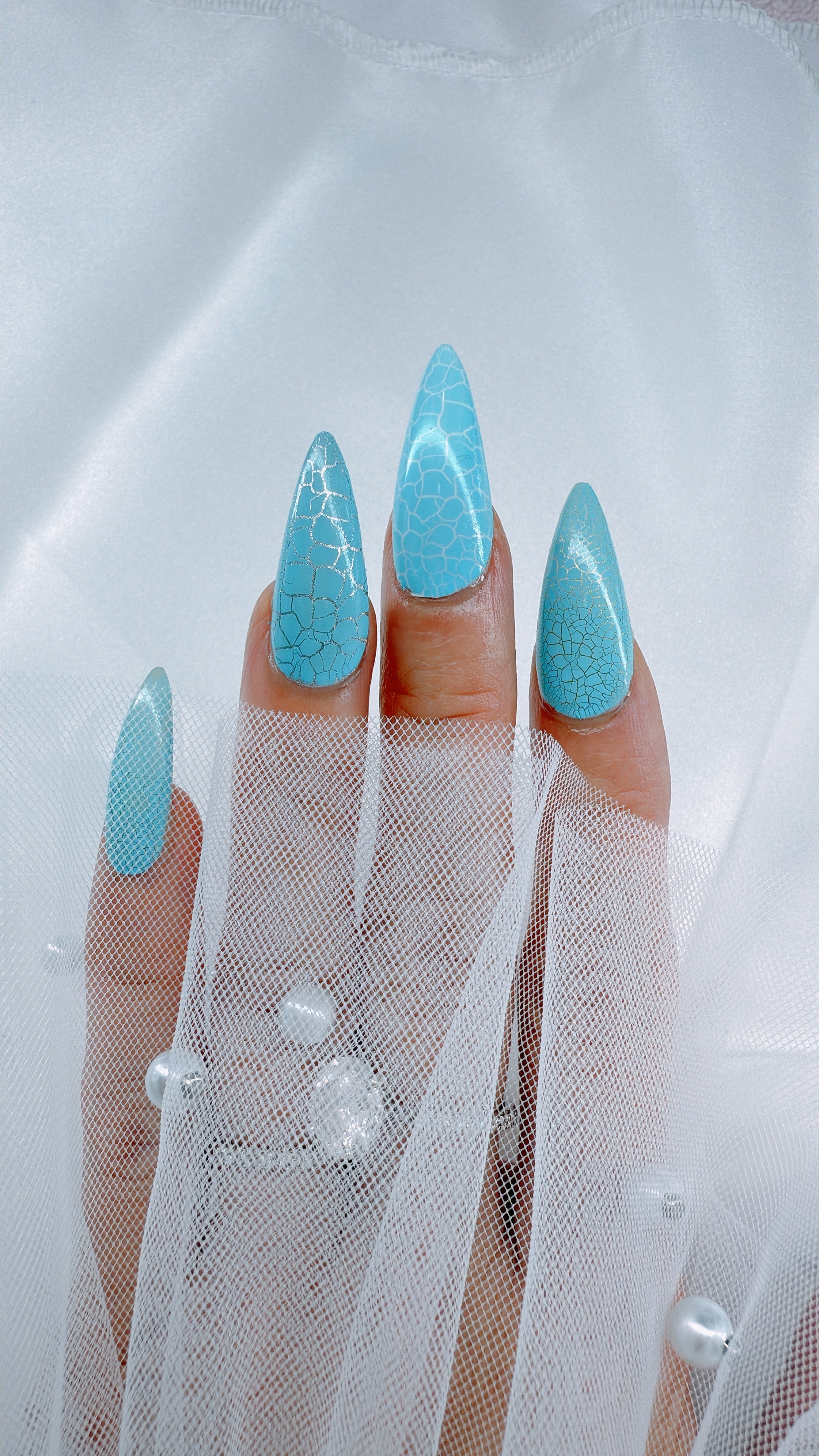 Turquoise crackle nail art on stiletto nails