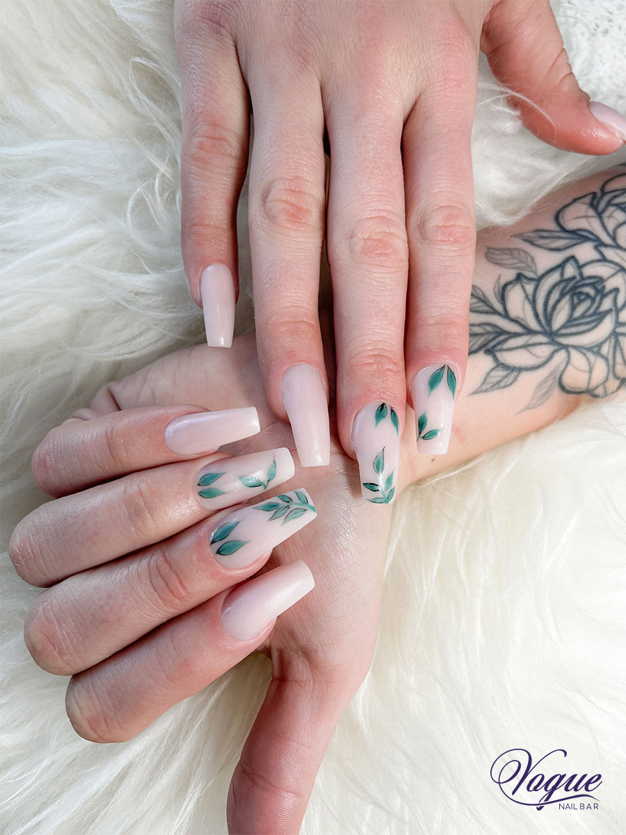 Pink and white ombre nails with teal leaf designs