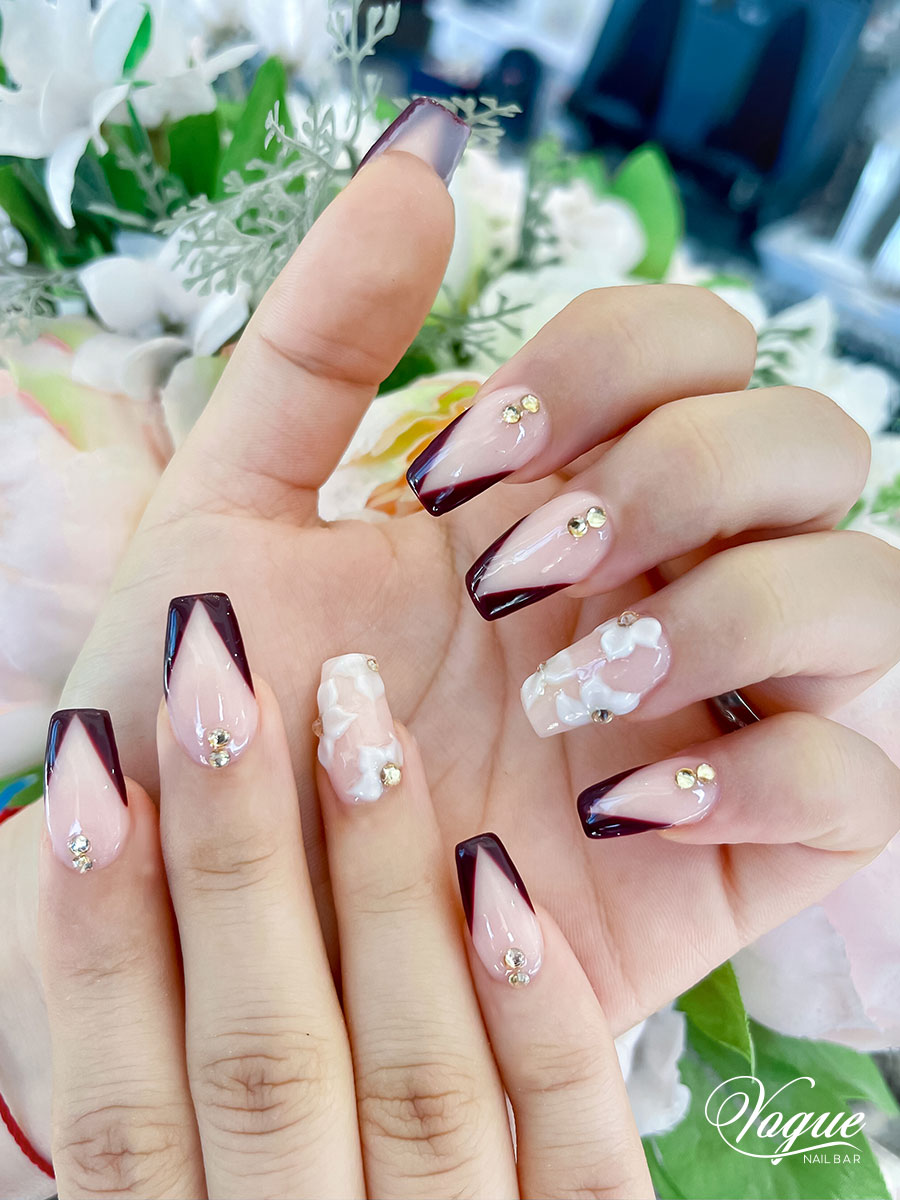 Nude and burgundy ombre nails with floral accents