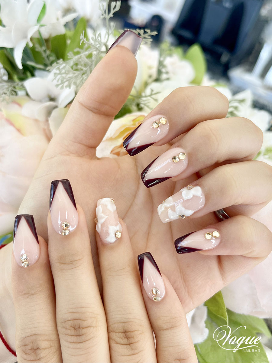 Burgundy and nude nails with floral accents