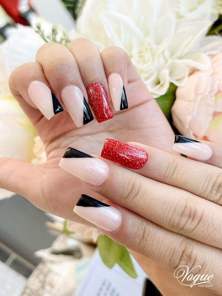 Festive nail art with pink bases and black triangular tips